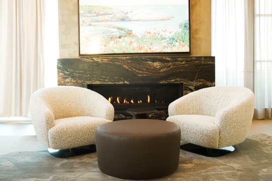 Boucle chairs by fireplace
